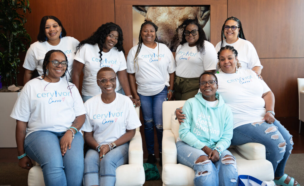 Cervivor community members of color, wearing Cervivor Cares shirts, smile together at the 2024 Communities of Color Retreat in Cleveland, OH. Tamika Felder has her arm around Gwen Jackson.