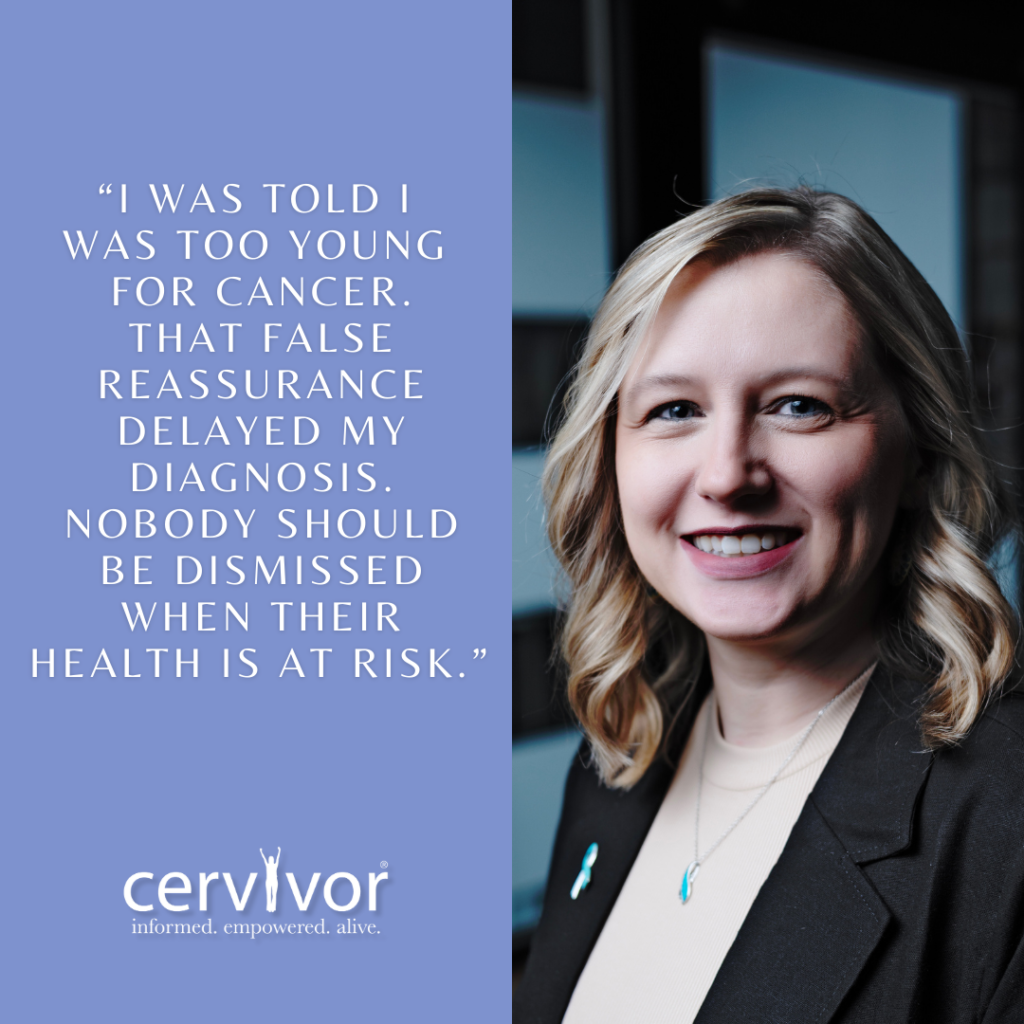 A Caucasian woman with blonde hair and a warm smile is shown on the right side of the image, wearing a black blazer over a cream-colored top and adorned with a necklace and a teal ribbon pin. On the left side, against a periwinkle blue background, a quote in white text reads: "I WAS TOLD I WAS TOO YOUNG FOR CANCER. THAT FALSE REASSURANCE DELAYED MY DIAGNOSIS. NOBODY SHOULD BE DISMISSED WHEN THEIR HEALTH IS AT RISK." At the bottom left, the logo for "cervivor" appears with the tagline "informed. empowered. alive."