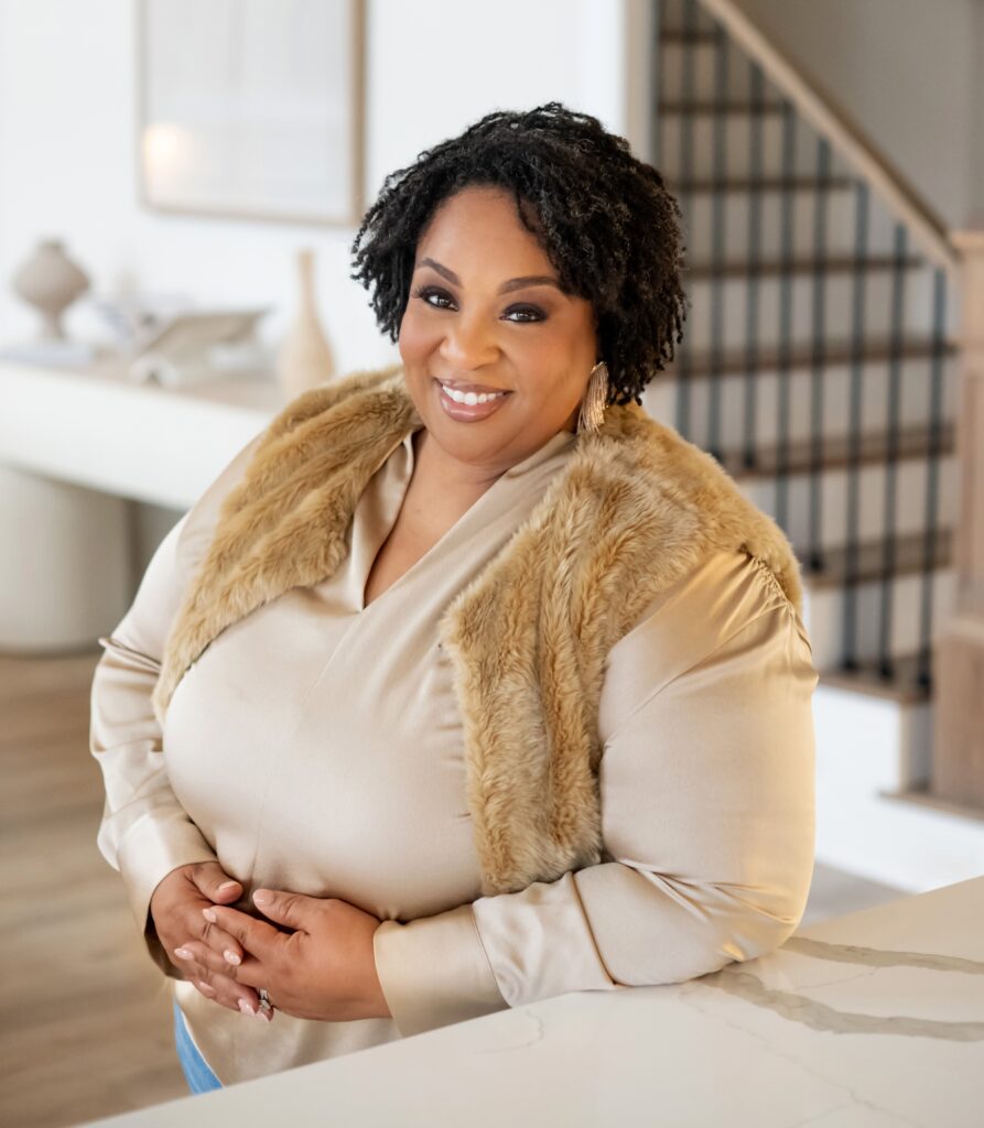 Tamika Felder, cervical cancer survivor and founder of Cervivor, smiling in a professional indoor portrait